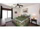 Cozy bedroom featuring a ceiling fan, a window that allows natural light to enter, and wildlife-themed decor at 45558 W Mountain View Rd, Maricopa, AZ 85139