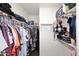 Spacious walk-in closet with shelving and ample storage for clothes and personal items at 45558 W Mountain View Rd, Maricopa, AZ 85139