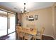 Dining area features a wooden table and chairs, a chandelier, and a sliding glass door to the patio at 45558 W Mountain View Rd, Maricopa, AZ 85139