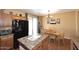 Bright eat-in kitchen features wood cabinets, black refrigerator and a dining table with chairs at 45558 W Mountain View Rd, Maricopa, AZ 85139
