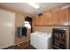 Functional laundry room with a washer, a dryer, and storage cabinets at 45558 W Mountain View Rd, Maricopa, AZ 85139