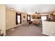 Large living room with a view into the kitchen, ceiling fan, and comfortable seating at 45558 W Mountain View Rd, Maricopa, AZ 85139