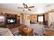 Open living space with an entertainment unit, a ceiling fan, and ample seating at 45558 W Mountain View Rd, Maricopa, AZ 85139