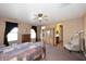 Spacious main bedroom with carpet, natural light, and en-suite bathroom and walk-in closet at 45558 W Mountain View Rd, Maricopa, AZ 85139