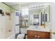 Bathroom featuring a shower-tub combo, wood-toned vanity, and decorative shelves at 5110 W Fulton St, Phoenix, AZ 85043