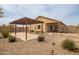 Well-maintained backyard featuring a pergola-covered patio and low-maintenance gravel landscaping, great for entertaining at 5123 S 235Th Dr, Buckeye, AZ 85326