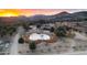 Scenic aerial view of a sprawling ranch with a central pond, surrounded by lush trees and rolling hills at 51238 N Pinal Ranch Rd, Miami, AZ 85539