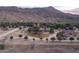 Expansive ranch property with winding paths and a charming pond against a backdrop of rugged mountains at 51238 N Pinal Ranch Rd, Miami, AZ 85539