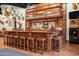 Rustic bar area featuring a wooden bar with seating for ten and western decor at 51238 N Pinal Ranch Rd, Miami, AZ 85539