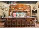 Custom bar with views of the outdoors, ample seating, and western decor at 51238 N Pinal Ranch Rd, Miami, AZ 85539
