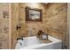 Enjoy a relaxing bath in this tub with travertine tile surround and an elegant soaking tub at 51238 N Pinal Ranch Rd, Miami, AZ 85539