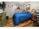Cozy bedroom features rustic wood floors, a comfortable bed, and Western-themed decor at 51238 N Pinal Ranch Rd, Miami, AZ 85539