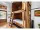 Rustic bunk beds with unique wood design and ladder in cozy room at 51238 N Pinal Ranch Rd, Miami, AZ 85539