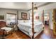 Primary bedroom featuring a four-poster bed and wood floors at 51238 N Pinal Ranch Rd, Miami, AZ 85539