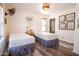 Cozy bedroom with comfortable twin beds, a vintage fan, and beautiful rustic wood look flooring at 51238 N Pinal Ranch Rd, Miami, AZ 85539
