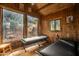 Cozy cabin bedroom with rustic wood paneling and outdoor views at 51238 N Pinal Ranch Rd, Miami, AZ 85539