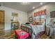 Charming bedroom with hardwood floors, an iron bed, and vintage furnishings create a cozy retreat at 51238 N Pinal Ranch Rd, Miami, AZ 85539