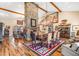 Spacious dining room featuring stone fireplace, wood floors, beamed ceiling and southwestern style rug at 51238 N Pinal Ranch Rd, Miami, AZ 85539