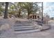 Beautiful cabin with a rock and wood staircase, surrounded by mature trees, a natural landscape, and gravel all around at 51238 N Pinal Ranch Rd, Miami, AZ 85539