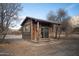 Rustic cabin with a covered porch nestled in a natural setting at 51238 N Pinal Ranch Rd, Miami, AZ 85539