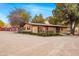 Exterior view of cozy desert home with large lot and mature trees at 51238 N Pinal Ranch Rd, Miami, AZ 85539