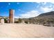 Scenic view with a rusted metal silo and a black cross set against a mountainous desert backdrop at 51238 N Pinal Ranch Rd, Miami, AZ 85539