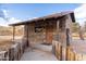 Rustic stone building with wood accents, featuring a covered porch and mature trees at 51238 N Pinal Ranch Rd, Miami, AZ 85539