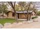 Exterior view of home surrounded by mature trees, rocks and landscaping at 51238 N Pinal Ranch Rd, Miami, AZ 85539
