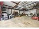 A large garage with ample room for parking and storage with various utility vehicles and lawn equipment at 51238 N Pinal Ranch Rd, Miami, AZ 85539