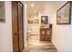 A cozy hallway with a charming cabinet, wood-look floors, neutral walls, and a full bathroom at 51238 N Pinal Ranch Rd, Miami, AZ 85539