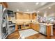 Gourmet kitchen with custom wood cabinets, stainless steel appliances, granite counters and hardwood floors at 51238 N Pinal Ranch Rd, Miami, AZ 85539