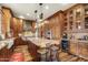 Beautiful kitchen with custom cabinets, a large island, granite countertops, and stainless steel appliances at 51238 N Pinal Ranch Rd, Miami, AZ 85539