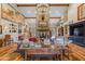 Warm living room with a striking stone fireplace, hardwood floors, and eclectic western decor at 51238 N Pinal Ranch Rd, Miami, AZ 85539
