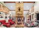Grand living room with a soaring stone fireplace, exposed beams, and stylish western-themed decor at 51238 N Pinal Ranch Rd, Miami, AZ 85539