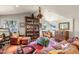 Spacious living room featuring a large bookcase and warm, inviting furniture arranged on a colorful rug at 51238 N Pinal Ranch Rd, Miami, AZ 85539