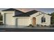 Charming single-story stucco home featuring a tile roof, front-facing garage, and a landscaped front yard at 5206 W Top Hand Trl, Laveen, AZ 85339