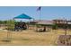 Enjoy community amenities with this playground with a covered play structure, picnic tables, and well-maintained landscaping at 5206 W Top Hand Trl, Laveen, AZ 85339