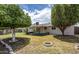 Expansive backyard boasting lush green grass and mature trees at 6820 E Pinchot Ave, Scottsdale, AZ 85251
