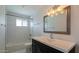 Stylish bathroom featuring a shower, tile floors, and a modern vanity with great lighting at 6820 E Pinchot Ave, Scottsdale, AZ 85251