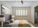 Cozy bedroom featuring neutral tones, shuttered windows, and a spacious closet at 6820 E Pinchot Ave, Scottsdale, AZ 85251