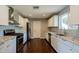 Well-equipped kitchen featuring white cabinets, granite countertops, and stainless steel appliances at 6820 E Pinchot Ave, Scottsdale, AZ 85251