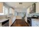 Modern kitchen featuring white cabinets, granite countertops, stainless steel appliances, and hardwood flooring at 6820 E Pinchot Ave, Scottsdale, AZ 85251