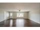 Spacious living room with hardwood floors and a large window, providing ample natural light at 6820 E Pinchot Ave, Scottsdale, AZ 85251