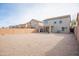 Spacious gravel backyard with a covered patio, enclosed by brick fencing for privacy at 896 E Dragon Fly Rd, San Tan Valley, AZ 85143