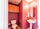 Compact powder room with a pedestal sink, toilet, and storage cabinet at 896 E Dragon Fly Rd, San Tan Valley, AZ 85143
