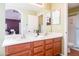 Bathroom featuring double sink vanity with wood cabinets, framed mirrors, and decorative lighting at 896 E Dragon Fly Rd, San Tan Valley, AZ 85143