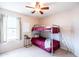 Bedroom with a bunk bed, ceiling fan, and a window offering natural light at 896 E Dragon Fly Rd, San Tan Valley, AZ 85143