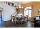 Open-concept dining area with a chandelier, wood table, staircase and wood laminate flooring at 896 E Dragon Fly Rd, San Tan Valley, AZ 85143