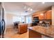 Well-lit kitchen with wood cabinets, granite countertops, and stainless steel appliances at 896 E Dragon Fly Rd, San Tan Valley, AZ 85143