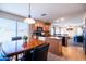 Open kitchen with an island leads to a dining area with a wooden table and upholstered chairs at 896 E Dragon Fly Rd, San Tan Valley, AZ 85143